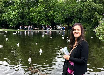Dr. Usha Yadav visiting a duck pond on a cloudy summer day